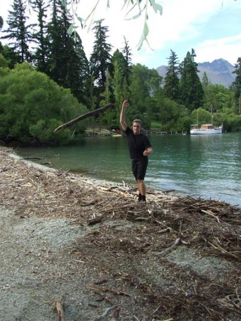 A Bathhouse staff member moves driftwood from in front of the restaurant yesterday morning. Photo...