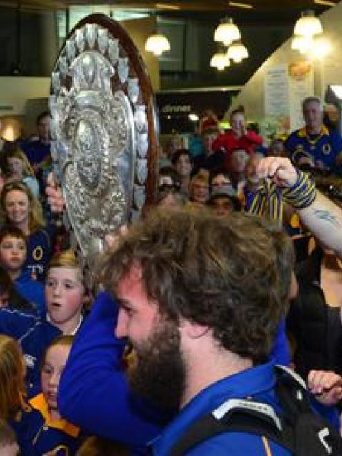 A bemused Liam Coltman looks on as the shield moves through the crowd.