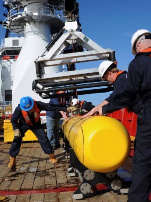 A Bluefin 21 autonomous underwater vehicle is hoisted on board the Australian Defence Vessel...