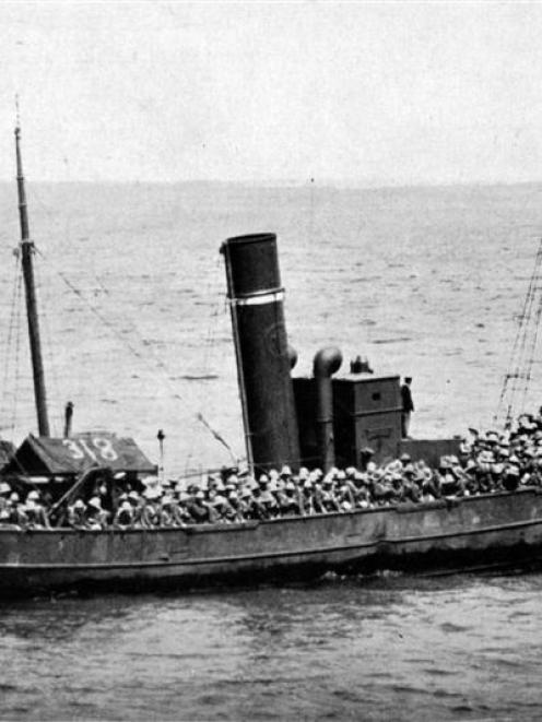 A boat load of soldiers from the Sixth Lancashire Fusiliers leaves the S. S. Nile for a landing...