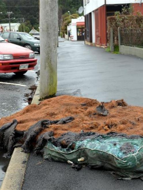 A burnt mattress lies in Howe St in Dunedin yesterday afternoon. Photo by Peter McIntosh.