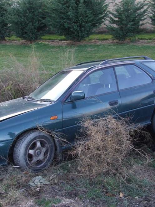 A car in a ditch off Malaghans Rd. Photo by Christina McDonald.