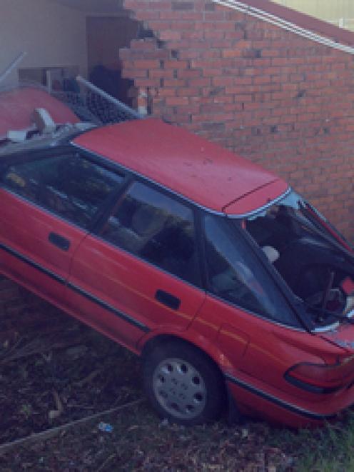 A car is embedded in a house after a crash on the corner of Dreadon Avenue and Rangitoto Road in...