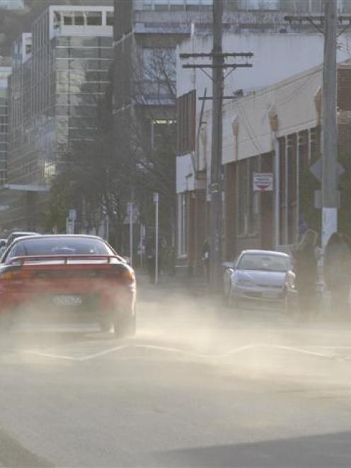 A car throws up a cloud of dust in Albany St, Dunedin, where airborne dirt and soil particles...