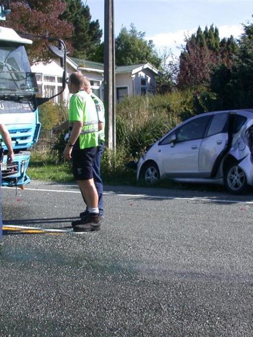 A car transporter is checked by its driver and police after rear-ending a small hatchback just...