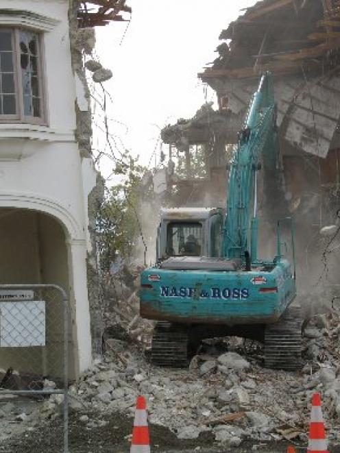 A contractor demolishes a building on Tennyson St to make 
...