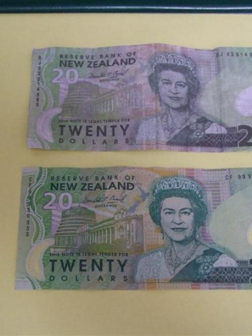 A counterfeit $20 note (top) compared with a real $20 note (bottom). Photo by Glenn Conway.