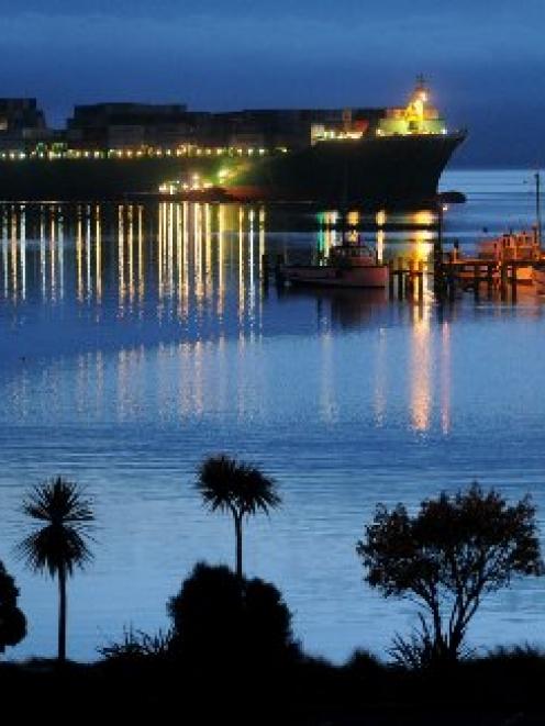 A crayfish boat prepares to head out of Careys Bay about 6am last Thursday as the container ship...