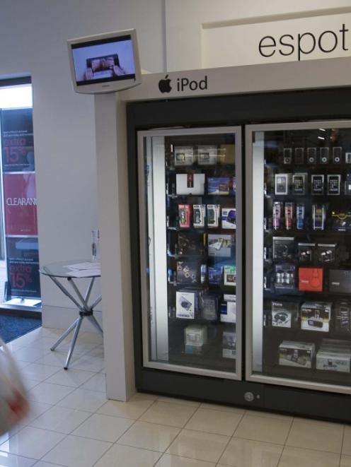 A customer walks past an e-Spot at the Macy's store in Town Centre Plaza in Leawood, Kansas. The...