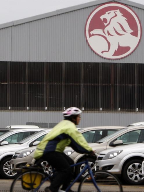 A cyclist rides past a General Motors (GM) Holden storage facility in Melbourne. Photo by Reuters