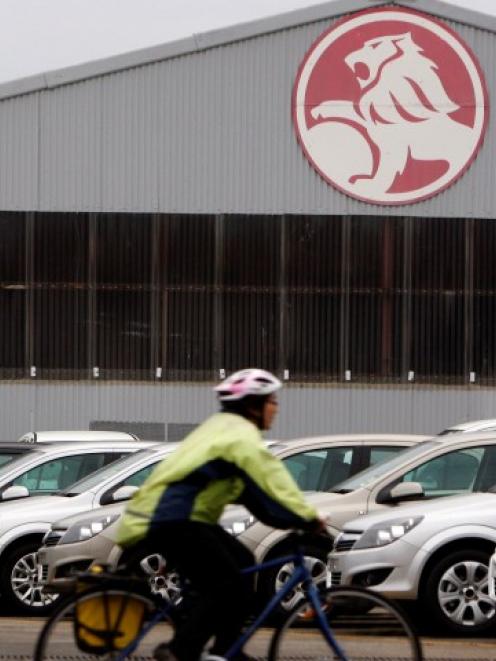 A cyclist rides past Holden storage facility in Melbourne. REUTERS/Mick Tsikas/Files