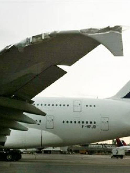 A damaged Air France Airbus A380 sits on the runway after clipping a much smaller Bombardier...