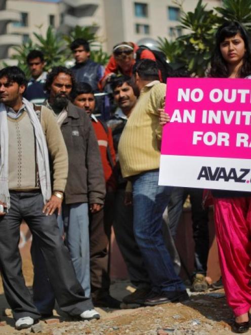 A demonstrator holds a placard during a protest outside a court in New Delhi yesterday. REUTERS...