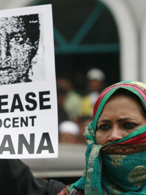 A demonstrator holds an image of Rizana Nafeek, jailed in Saudi Arabia on charges of murdering a...