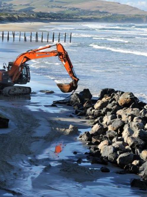 A ditch-digger works on a pile of rocks on St Clair Beach yesterday. Photos by Craig Baxter.