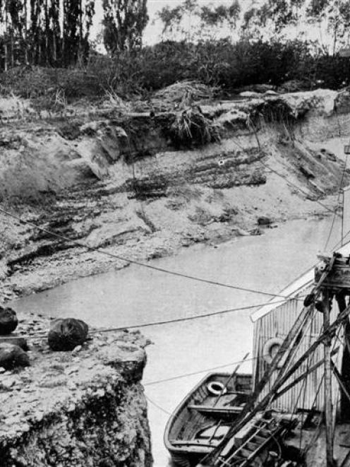 A dredge in its paddock near Alexandra, 30ft above the Molyneux, cutting into a beautiful bit of...