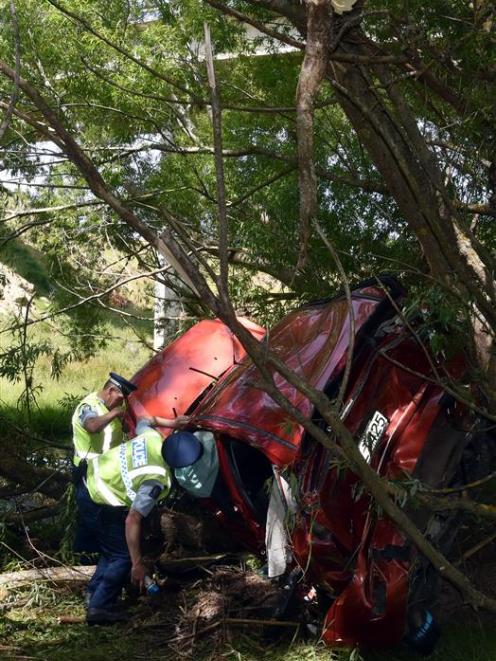 A driver is removed from a car that plunged over 50 metres into Lee Stream on Thursday morning....