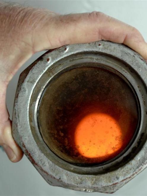 A  Dunedin City Council staff member examines a peephole into the incinerator at the Tahuna...