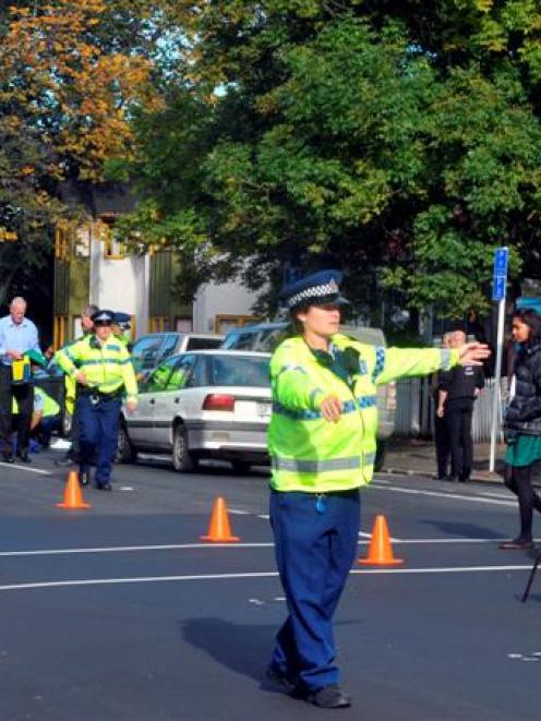 A Dunedin police officer directs traffic off Cumberland St where an elderly male pedestrian was...