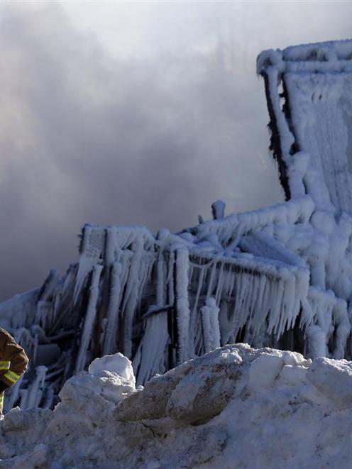 A firefighter looks on at the seniors residence Residence du Havre after a fire in L'Isle Verte,...