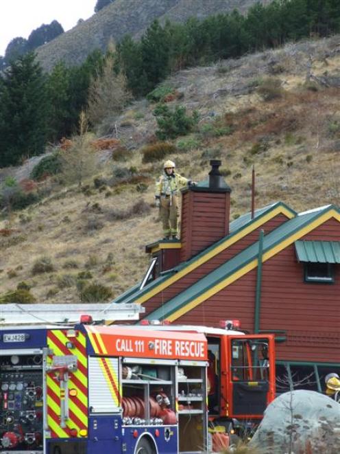 A fireman atop the roof of the house  during a callout to what was thought to be a chimney fire...