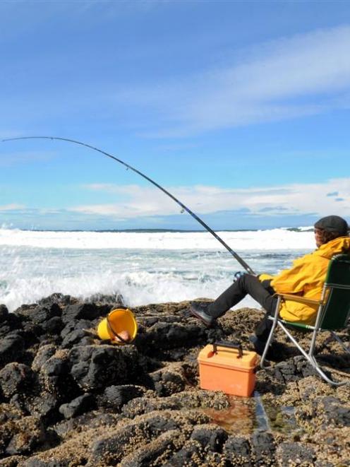 A fisher claims his patch of the Otago coast. Photo by Stephen Jaquiery.