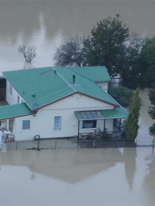 A flooded farmhouse on the Taieri in April 2006.  Photo by Peter McIntosh.