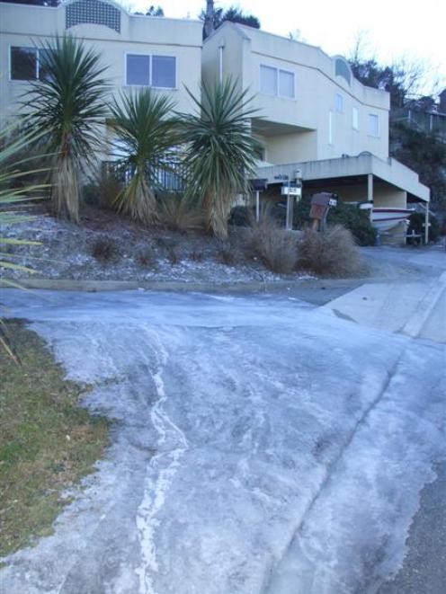 A frozen flow of water emerges from a burst pipe on Richards Park Lane, in Fernhill, Queenstown....