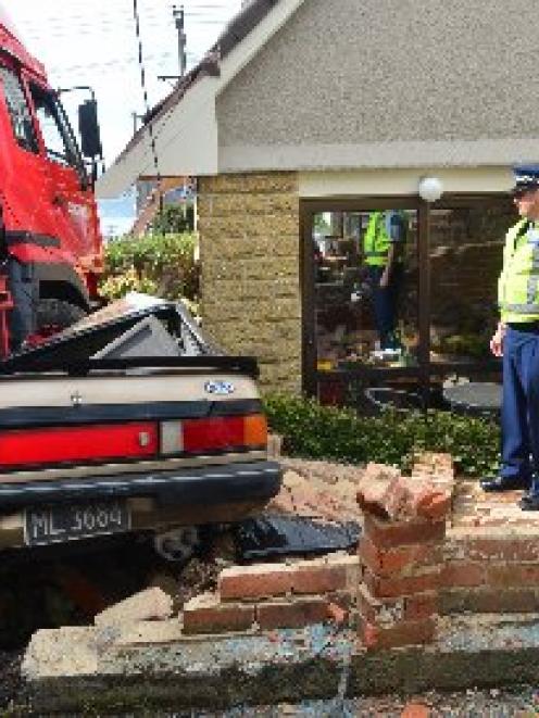 A furniture removal truck comes to rest against  a house on the corner of  Arthur St on Saturday...