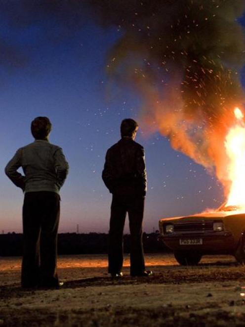 A getaway car burns in the film.