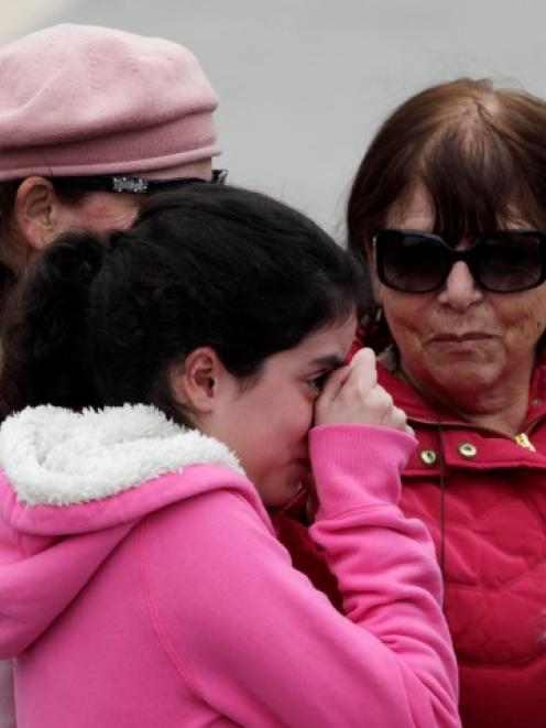 A girl cries as she stands in front of Ariel Sharon's coffin outside the Knesset in Jerusalem....