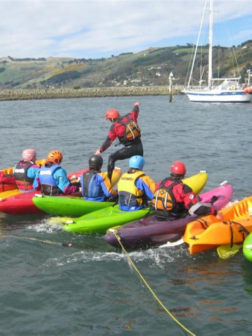 A group kayak-walking stunt on the Boat Harbour, Dunedin builds confidence. Photo supplied.