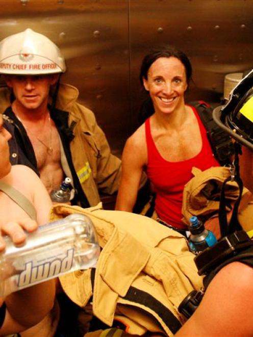 A group of firefighters make their way to the bottom of sky Tower after crossing the finish line...