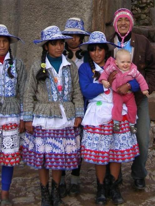 A group of young people in national dress pose with Emelia. Photo by David King.