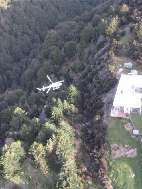 A helicopter passes over an Alpine Retreat property near Queenstown last night during a mock...