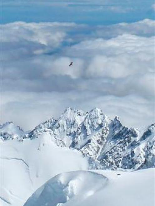 A helicopter  recovers the body of the Swedish climber who died after falling 600m on Mt Cook...