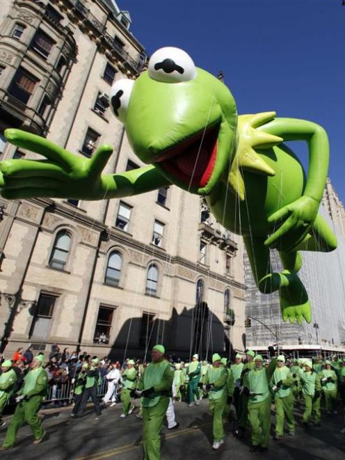 A Kermit the Frog balloon floats down Central Park West during the 85th Macy's Thanksgiving day...
