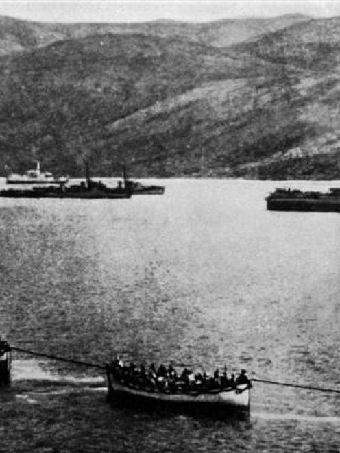 A landing party to reinforce the Australians near Gaba Tepe, Gallipoli, being towed in lifeboats...