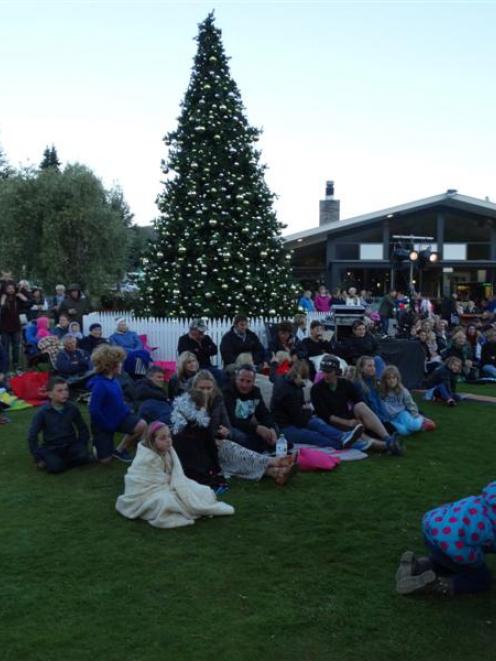 A large crowd gathers on the lawn of the Wanaka Hotel on Monday evening to listen to Christmas...