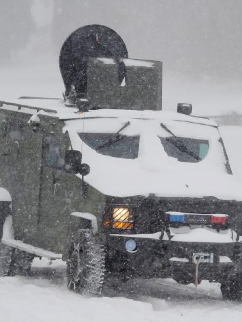 A Los Angeles county sheriff SWAT vehicle heads out in the heavy snow as the search continues for...