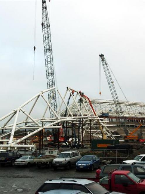 A main roof truss is hoisted into place at Forsyth Barr Stadium, in Dunedin, yesterday. Photo by...