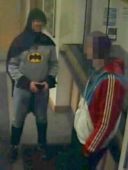 A man dressed as Batman and a burglary suspect stand in a police station in Bradford, northern...