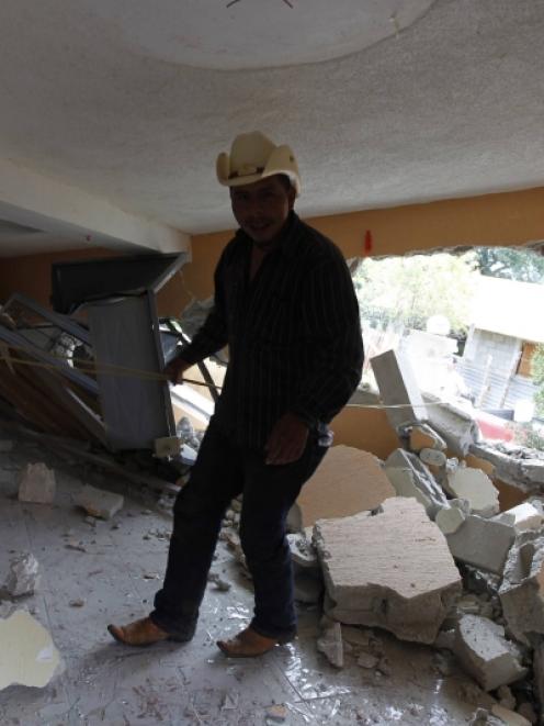 A man stands in an earthquake-damaged house in the San Marcos region, in the northwest of...
