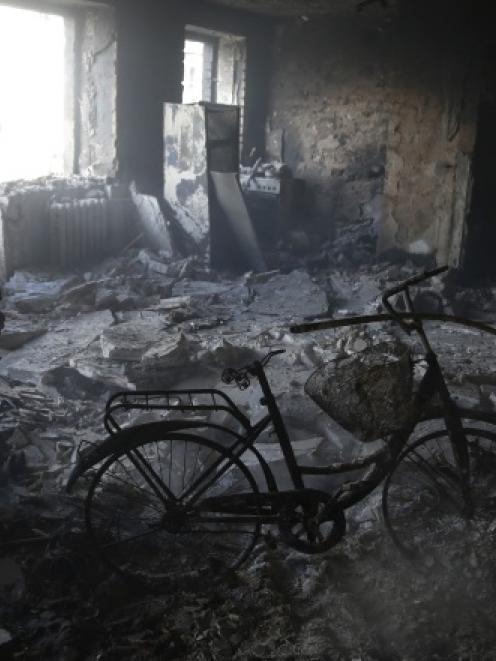 A man stands in the rubble of a building damaged by fighting in the city of Debaltseve. Photo by...