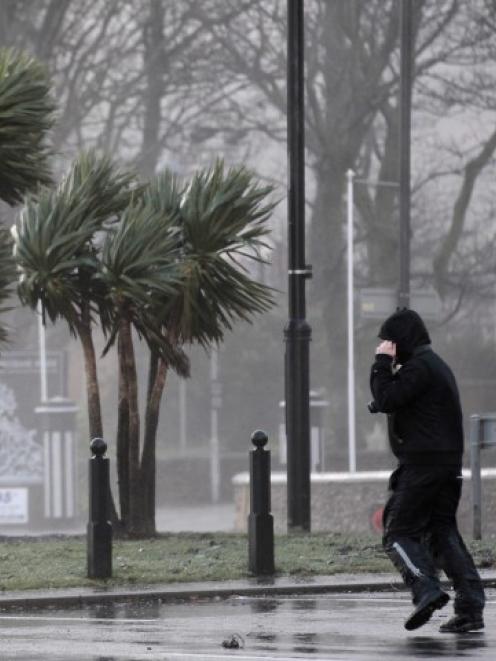 A man struggles against strong winds next to the promenade in Largs in west Scotland. REUTERS...