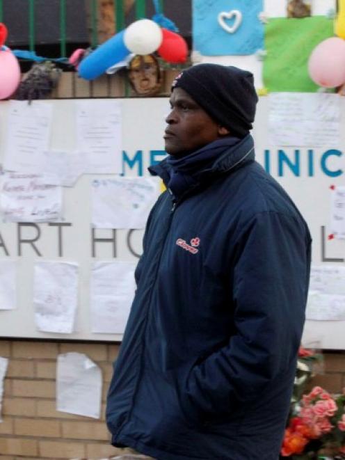 A man walks past messages of support for Nelson Mandela outside the Pretoria hospital where the...