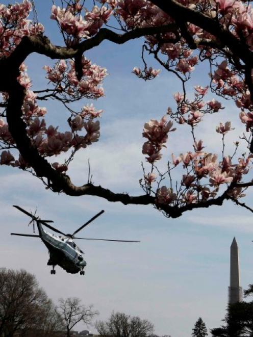 A Marine One helicopter carries US President Barack Obama away from the White House in Washington...