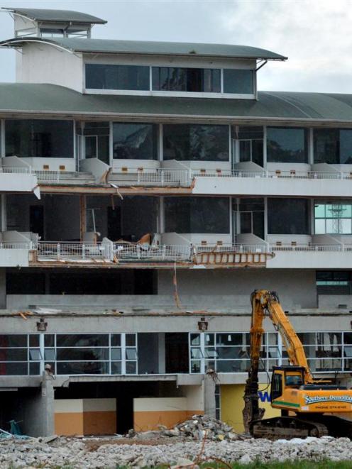A mechanical excavator stands beneath  Carisbrook's terrace hospitality complex as demolition of...