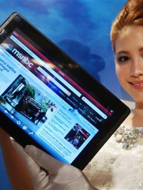 A model displays an AsusTek Eee Pad tablet computer at an AsusTek event in Taipei, Taiwan. The 10...