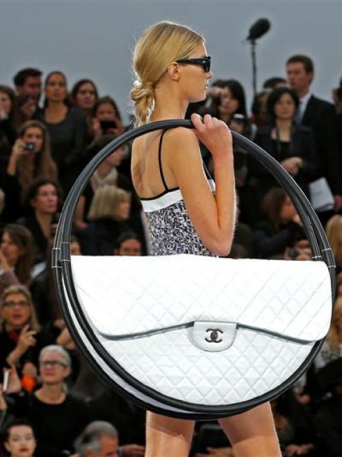 A model presents a creation by German designer Karl Lagerfeld for French fashion house Chanel. ...